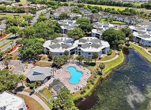 Un barrio residencial con varias casas, una piscina y un río.