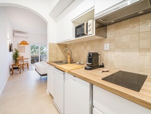 A modern kitchen with a dishwasher, a coffee machine, and a microwave. - Stylish Central Studio with Balcony, Lagos (Lagos)
