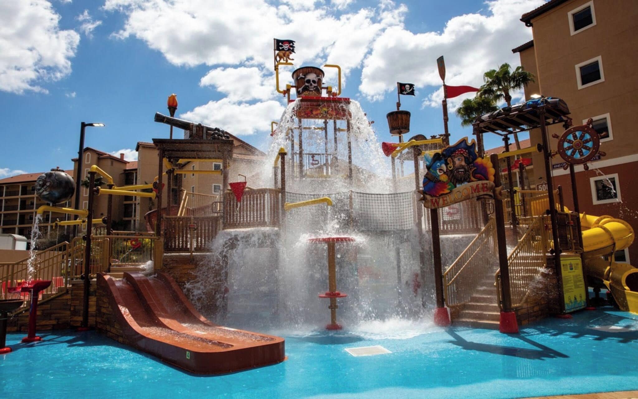 A water park with a central water feature, slides, and a pirate-themed design.