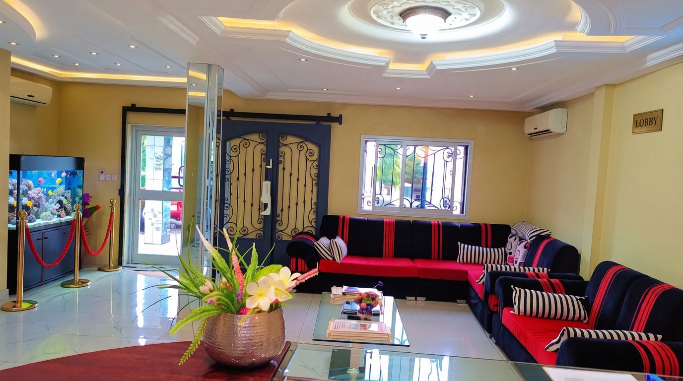 A modern living room with a red and black sofa set, a glass coffee table, and a decorative plant.