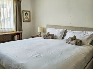 A neatly made bed with white linens, a bedside lamp, and rolled towels. - Fullun 14 by Interhome (St. Moritz)