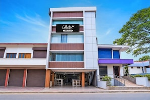 A multi-story building with a storefront labeled 'Collection' and 'OYO-Serviced.' - Collection O Virajpete Bus Terminal (Virajpet)