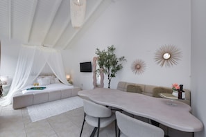 A modern bedroom with a bed, bedside table, and a large window. - Studio Sea by Casa Lou Lou modern central location with shared pool (Noord)