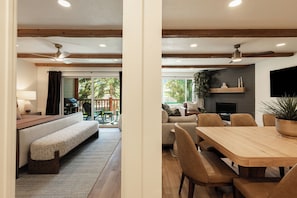 A modern interior with a sofa, dining table, chairs, and a fireplace. - Ski-in/ski-out 3BR condo with resort amenities and slope views. (Park City)