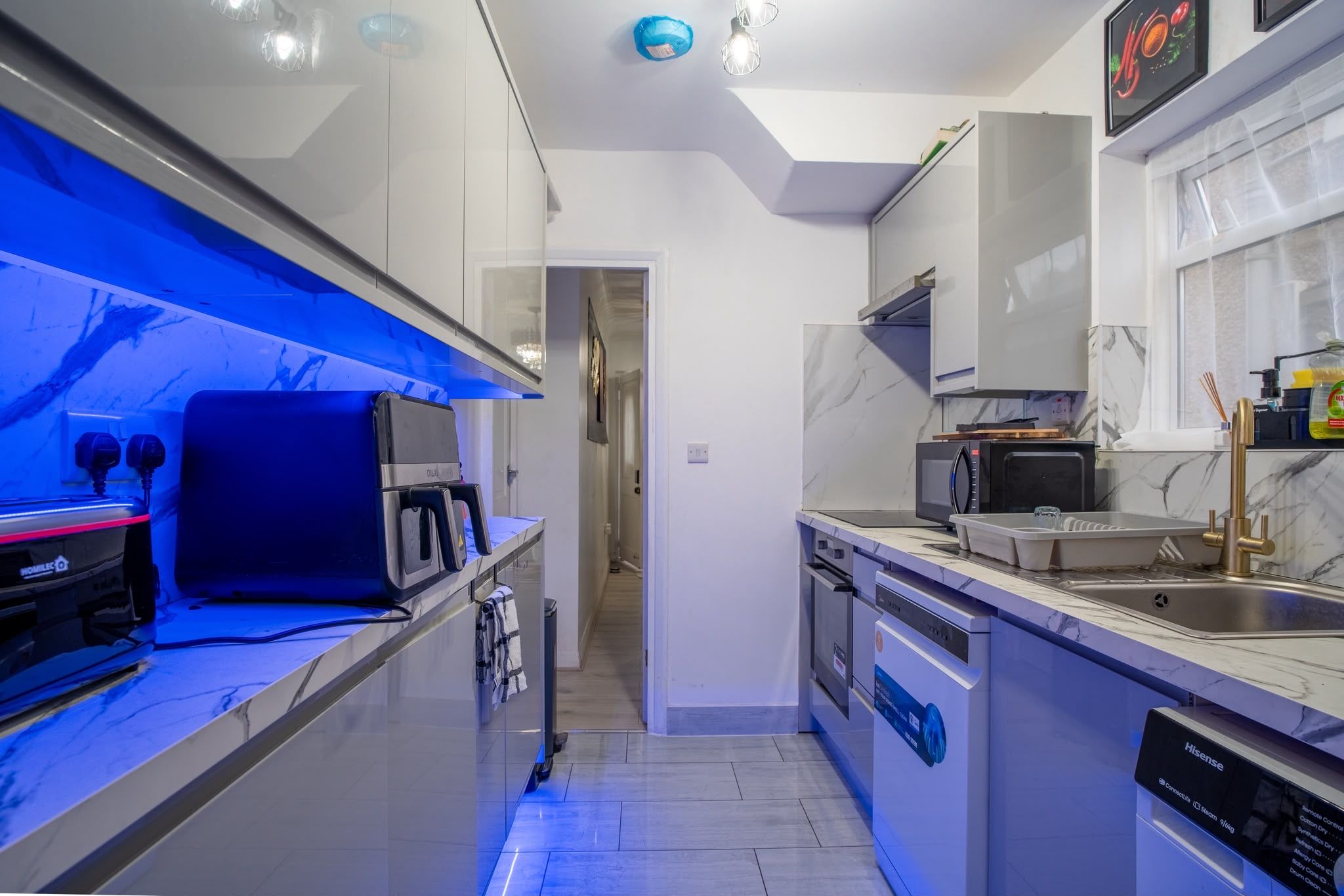 A modern kitchen with a microwave, oven, and dishwasher.