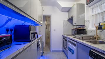 A modern kitchen with a microwave, oven, and dishwasher.