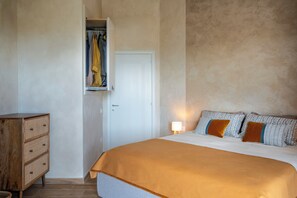 A bedroom with a bed, a dresser, and a wardrobe. - Villa Tigli: A 5-Minute Walk From the Beach by Top Villas Sardinia (Quartu Sant'Elena)