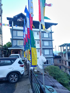 A multi-story building with a modern architectural design, featuring a mix of brick and glass facades. - Sunhill Ravangla Retreat (Ravangla)