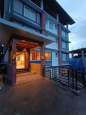 A multi-story building with a covered entrance and a visible staircase leading to the entrance. - Sunhill Ravangla Retreat (Ravangla)