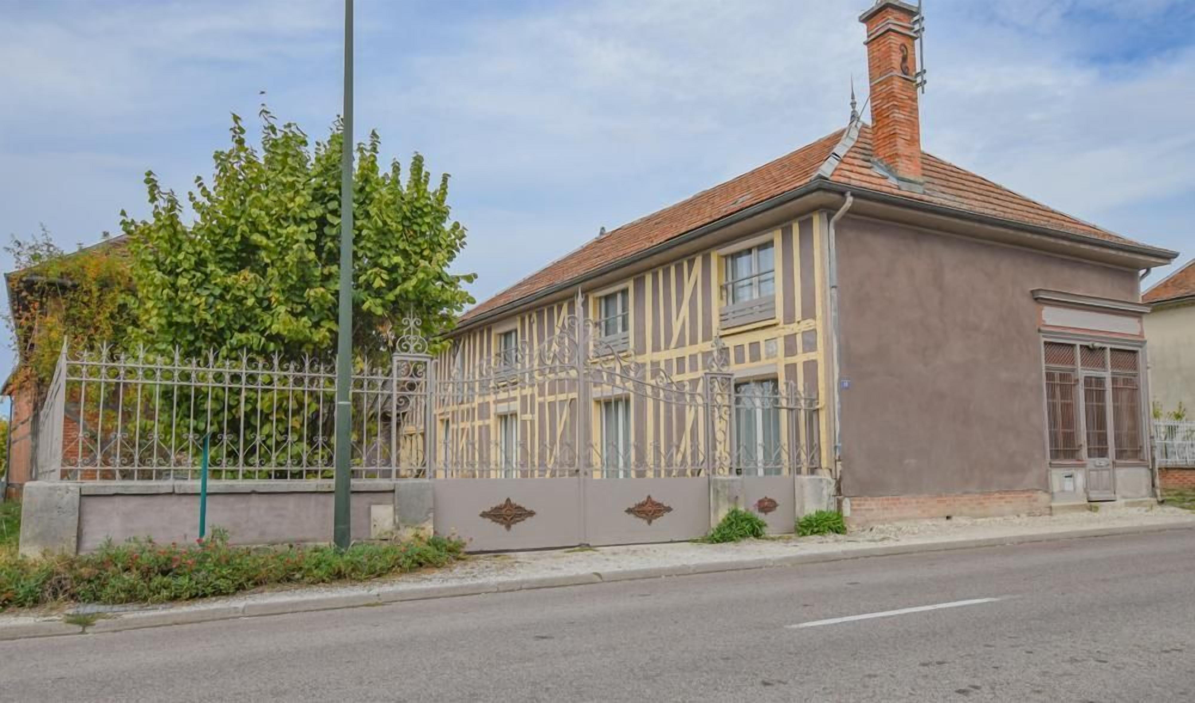 A building with a brick roof and a metal fence.