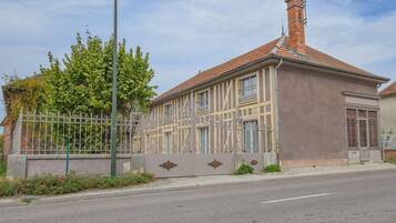 A building with a brick roof and a metal fence.