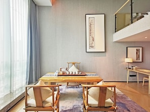 A modern dining area with a table, chairs, and a view of the city through large windows. - ROSEDALE HOTEL SHENZHEN (Shenzhen)