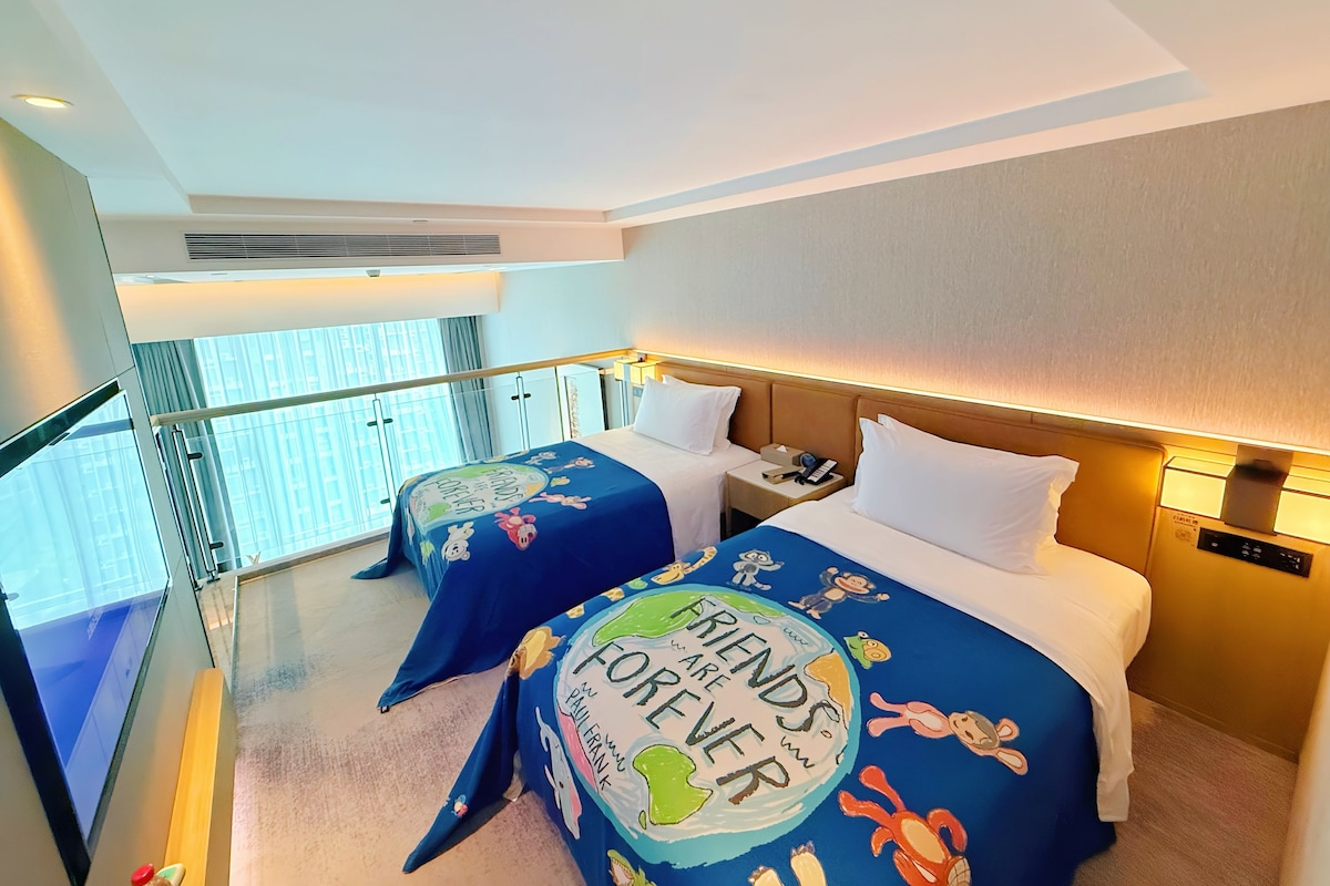 A hotel room with two beds, a balcony, and a view of the city.