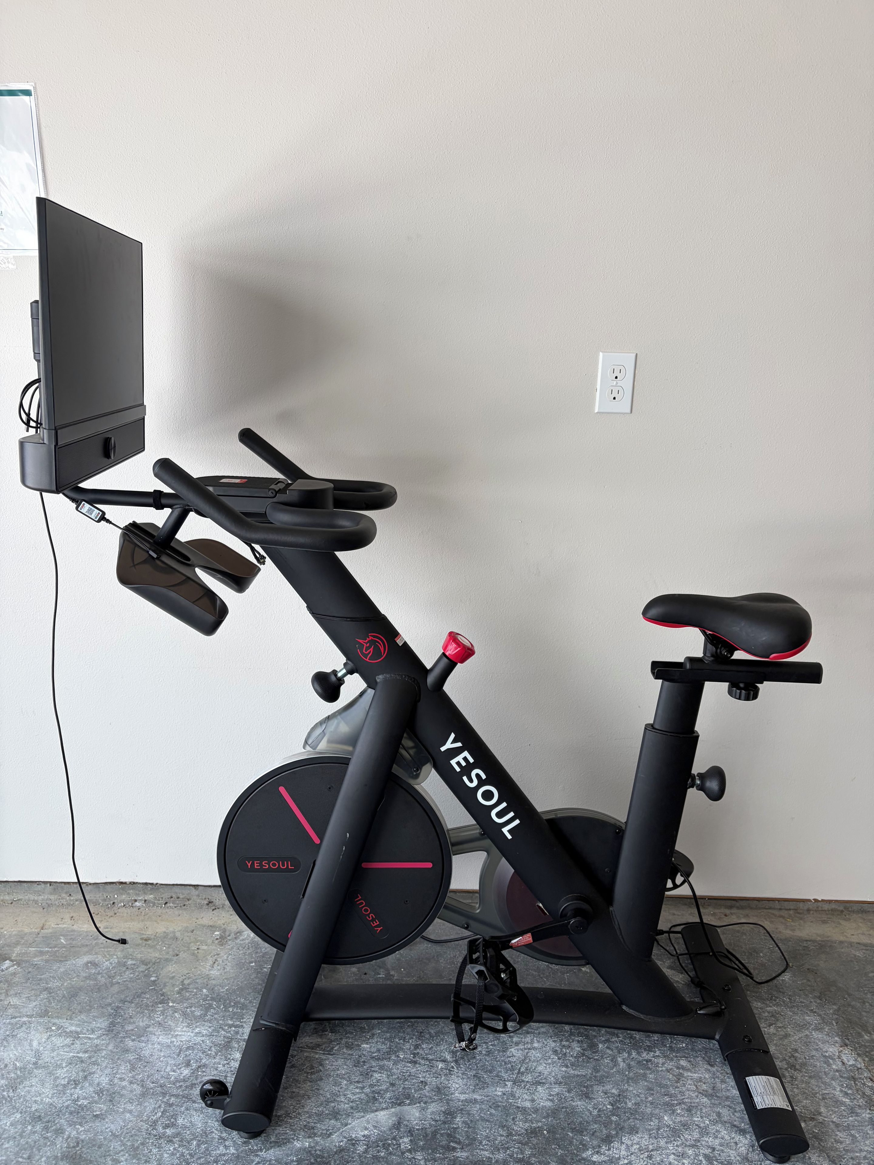 A stationary exercise bike with a digital display, a seat, handlebars, and a control panel.