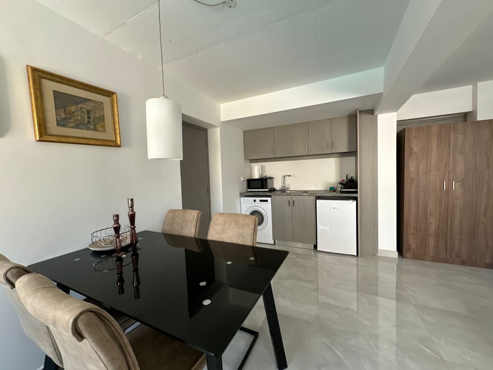 A modern kitchen with a dining area, including a table and chairs.