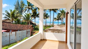 A balcony with a view of the beach and palm trees. - The Coastal Sunset (Gokarna)