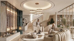 A modern interior with a central staircase, a fireplace, and a seating area with a sofa and a coffee table. - The Madison (Cape Town)