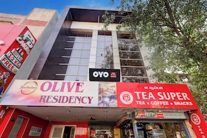 A building with signage for 'Olive Residency' and 'Tea Super' indicating a hotel and a tea shop. - Hotel O  The Olive Residency  (Chennai)