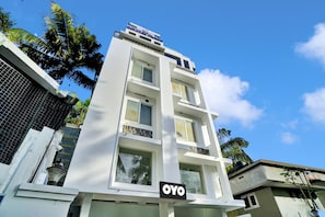 A multi-story building with a sign for 'Crystal Plaza' and 'OYO' hotel. - Hotel O Crystal Executive Suites (Kanayannur)