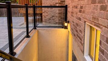 A staircase leading to a building with a brick exterior and a glass door at the top.