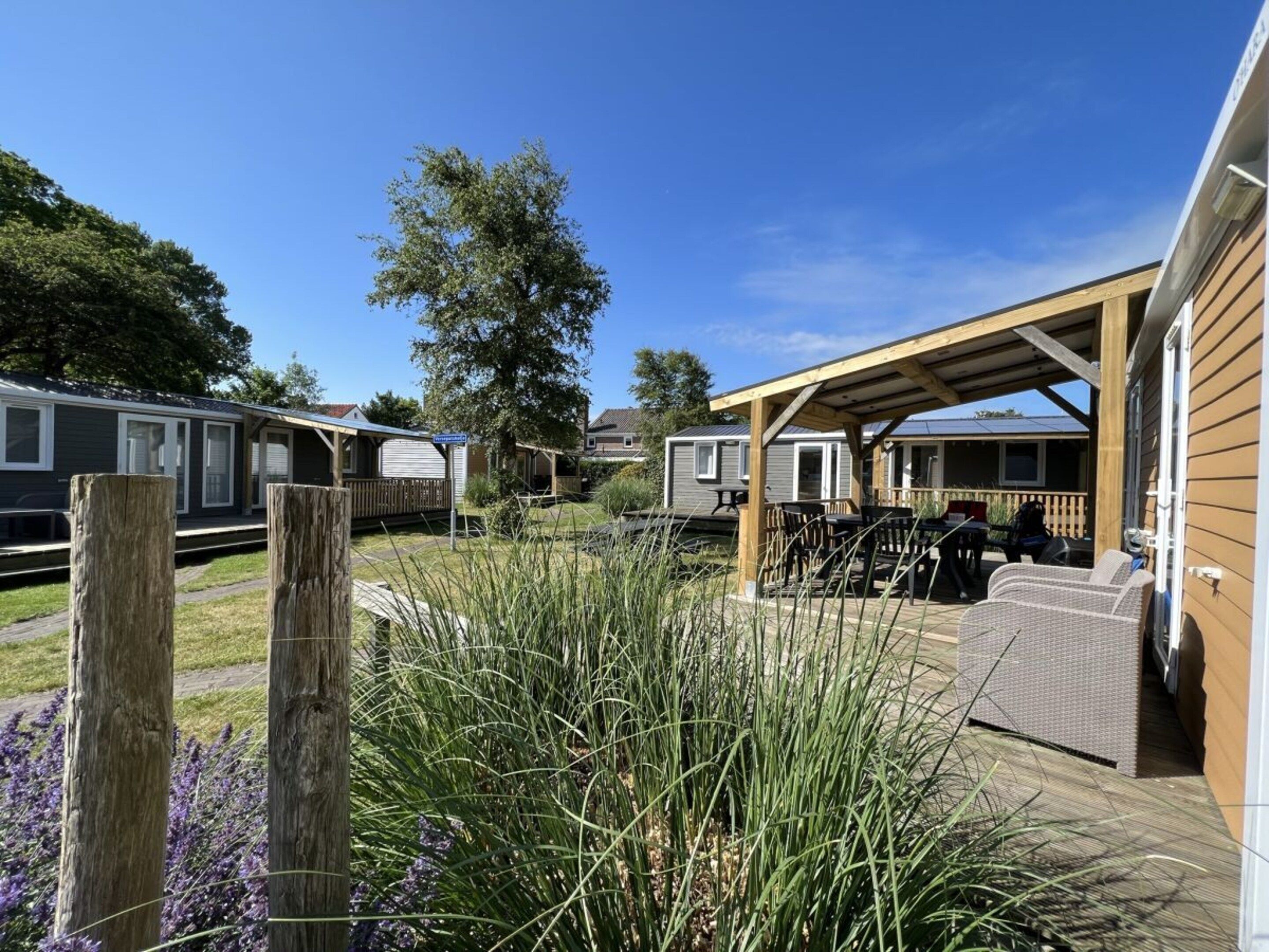 A caravan park with outdoor seating areas and a covered patio.