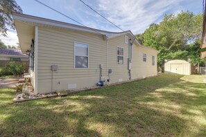 A single-story house with a garage, a small front yard, and a solar panel array on the roof. - Beach Escape 1 Mi to Okaloosa Island & Dtwn (Fort Walton Beach)
