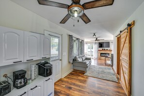 A modern kitchen with white cabinets, a coffee maker, and a ceiling fan. - Lakefront Escape in Vandalia: Ski, Fish & Stargaze (Vandalia)