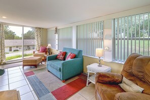A living room with a sofa, armchairs, a small table, and a window with blinds. - 'Livin' on Sunshine' Lake Louisa Escape! (Clermont)