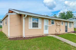 A single-story house with a front door, a window with shutters, and a small porch area. - 'Lake Life' Retreat in Clermont w/ Pool & Pier (Clermont)