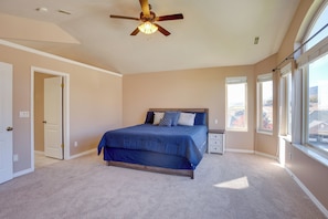 A bedroom with a bed, a nightstand, a ceiling fan, and large windows. - Extended Mtn-View Stay w/ Hot Tub Near Skiing (Mountain Green)