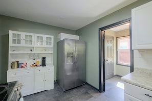 A kitchen with a stainless steel refrigerator, white cabinets, and a coffee maker. - Walk to VSU Campus! Your Escape away from home (South Chesterfield)