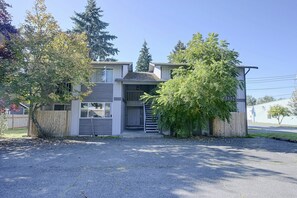 A two-story residential building with a garage, a covered porch, and a driveway. - Central Lacey Home: 3 Mi to Dtwn Olympia (Lacey)