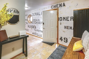 A hallway with a guest book, a door, and a wall with various names and numbers. - Spectacular Views & Moose Sightings! Fairbanks Gem (Fairbanks)