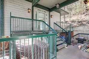 A wooden staircase with green railings leading to a porch area. - Dock Access, Deck & BBQ on Liberty Lake (Liberty Lake)