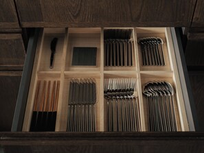 A drawer with neatly organized utensils including chopsticks, knives, and forks. - Toune Machiya House (Shimogyo-ku)