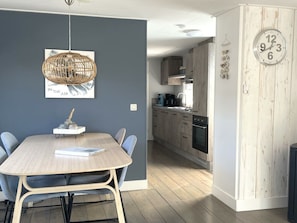 A modern kitchen with wooden cabinets and a built-in oven. - Chalet Special T32 (Makkum)