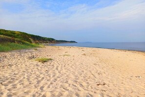A sandy beach with a clear sky and a calm sea. - Holiday home in Lancken with swimming pool (Lancken)