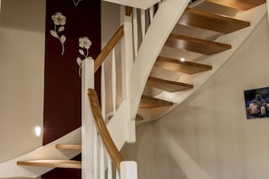 A spiral staircase with wooden steps and white railings. - Holiday apartment with 3 bedrooms (Born a. Darß)