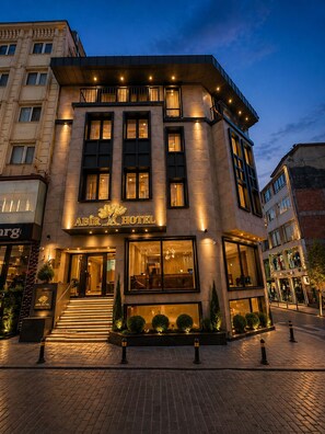 A hotel with a modern facade, large windows, and a well-lit entrance. - Abir Hotel (Fatih)