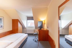 A hotel room with two beds, a desk with a chair, a television, and a window. - Sunday Hotel Leipzig Südvorstadt (Markgraf) - Standard Single Room (Leipzig)