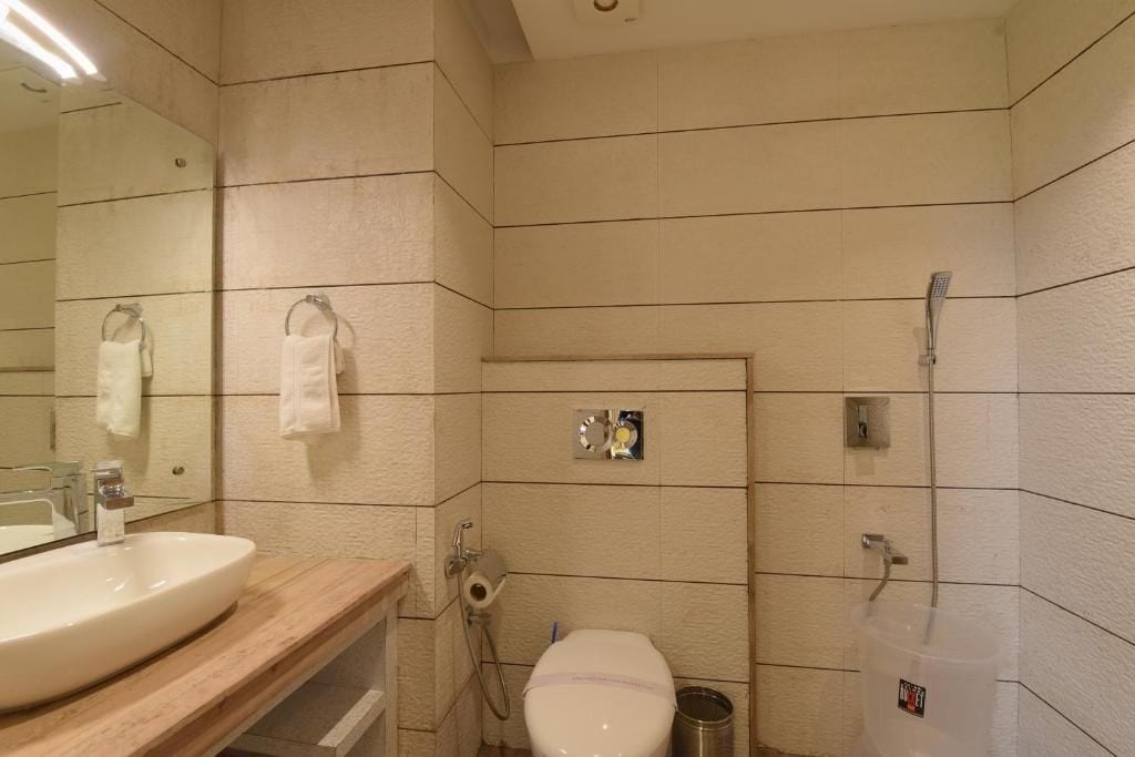 A bathroom with a sink, toilet, and shower.