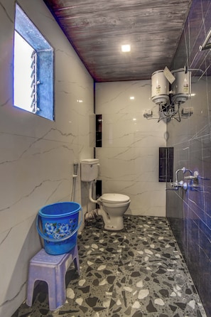 A bathroom with a toilet, a bidet, a shower, and a window. - Shivneri Valley Resort Mahabaleshwar  (Mahabaleshwar)