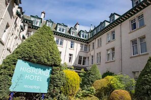 A hotel reception area with a sign for the Highland Hotel. - The Highland Hotel - Standard Single Room (Strathpeffer)