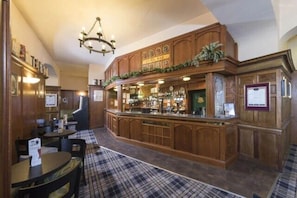 A bar area with wooden furnishings, a checkered floor, and a chandelier. - The Highland Hotel - Standard Single Room (Strathpeffer)