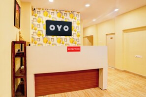 A reception desk with a sign that reads 'OYO' and a 'RECEPTION' sign below it. - Hotel O Sunshine Palace (Nagpur)