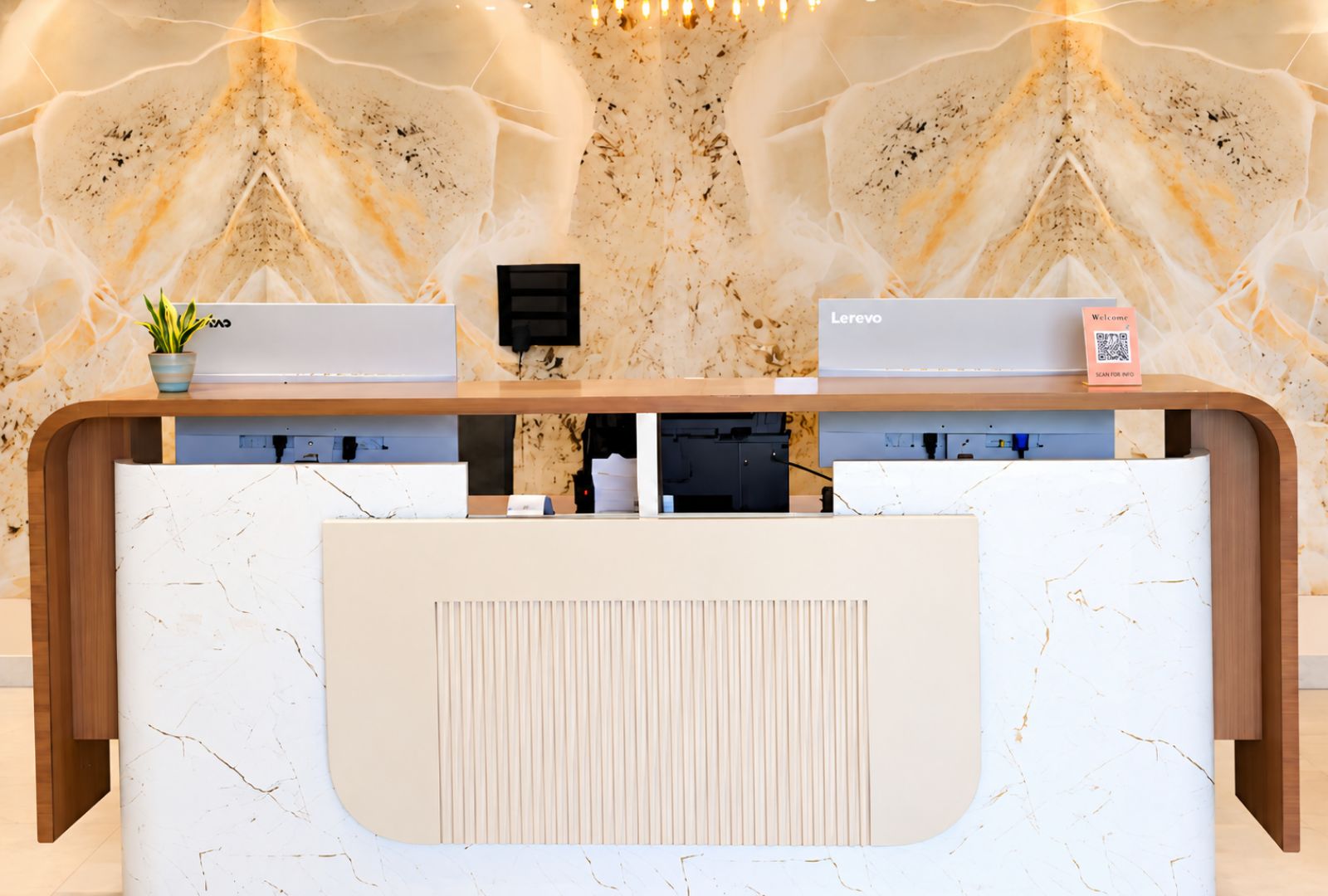 A reception desk with a marble-like pattern, a small plant, a QR code for information, and a 'Welcome' sign.