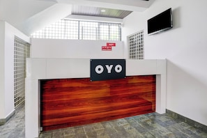 A reception desk with a sign that reads 'OYO' and a WiFi sign above it. - HOTEL O ROYAL INN (Nagpur)