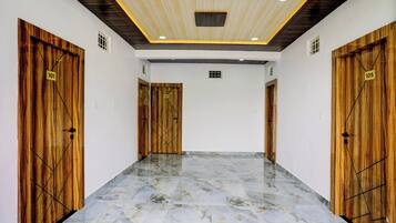 A hallway with wooden doors numbered 101, 103, and 105, leading to rooms.