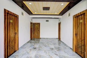A hallway with wooden doors numbered 101, 103, and 105, leading to rooms.