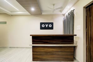 A reception desk with a sign that reads 'OYO' in a hotel lobby. - Hotel O Luxe Villa (Nagpur)